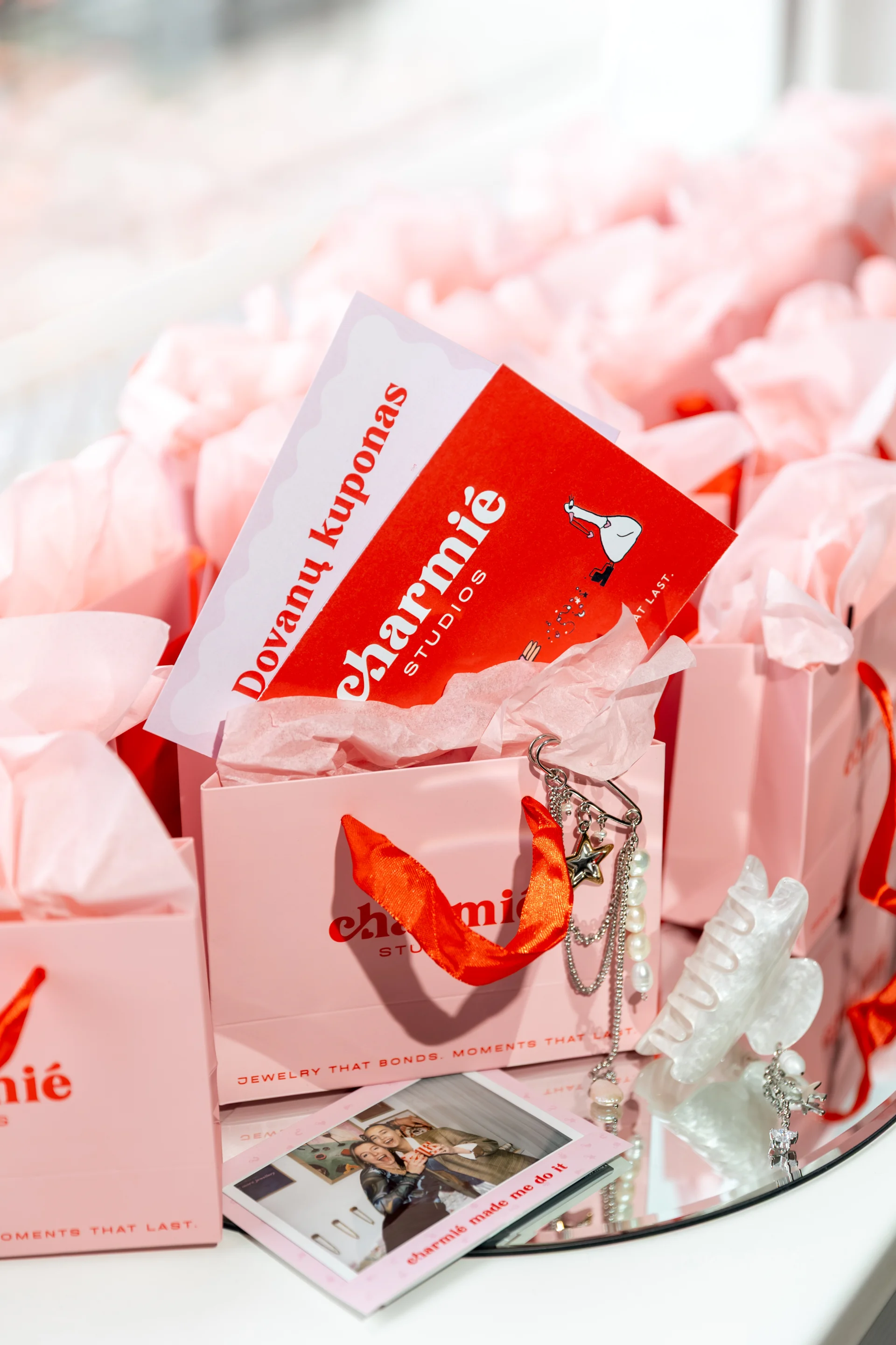 Charmié gift card in a pink gift bag
